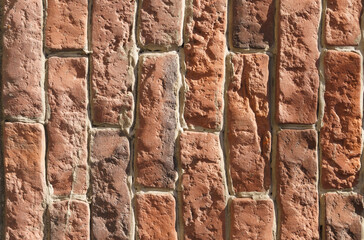 Large texture of a wall lined with red old bricks. Close-up.