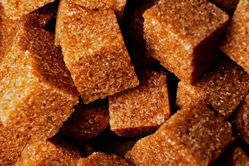 Organic brown sugar cubes macro background. Demerara sugar cubes - 527430223
