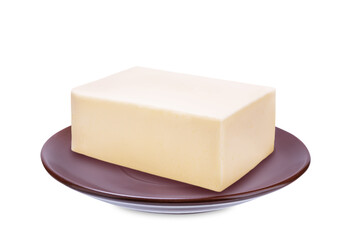 Fresh butter briquette in a brown plate on a white isolated background