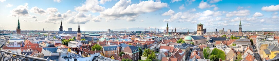 Panorama view Copenhagen, Denmark skyline from Round Tower (Rundetaarn), a 17th-century tower built as an astronomical observatory in the center of town. Aerial view of roofs and cityscape on a sunny 