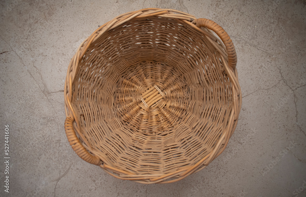 Wall mural wicker empty basket with handlers from top