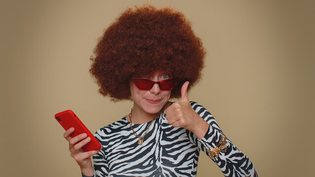 Pretty young female girl using smartphone typing new post on web, browsing, searching, addiction of social networks, show thumbs up like, positive feedback, recommends wifi cellular connection 5G