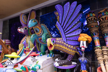 Alebrijes for sale in a traditional mexican shop, alebrije with eagle and fantasy animal forms,...
