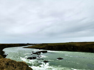 horizontal river water flow wild nature iceland grey clouds roadtrip