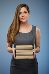 Smiling female teacher or student girl holding books stack isolated portrait.