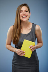 Happy young female teacher or business woman isolated portrait with book.