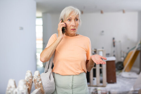 Mature Woman Designer Dissatisfied With Progress Of Inner Repair Works Having Emotional Phone Talk In House Under Reconstruction