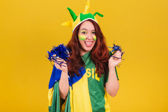 caucasian, red-haired woman, soccer fan from brazil, dancing wearing cheerleader pom poms.