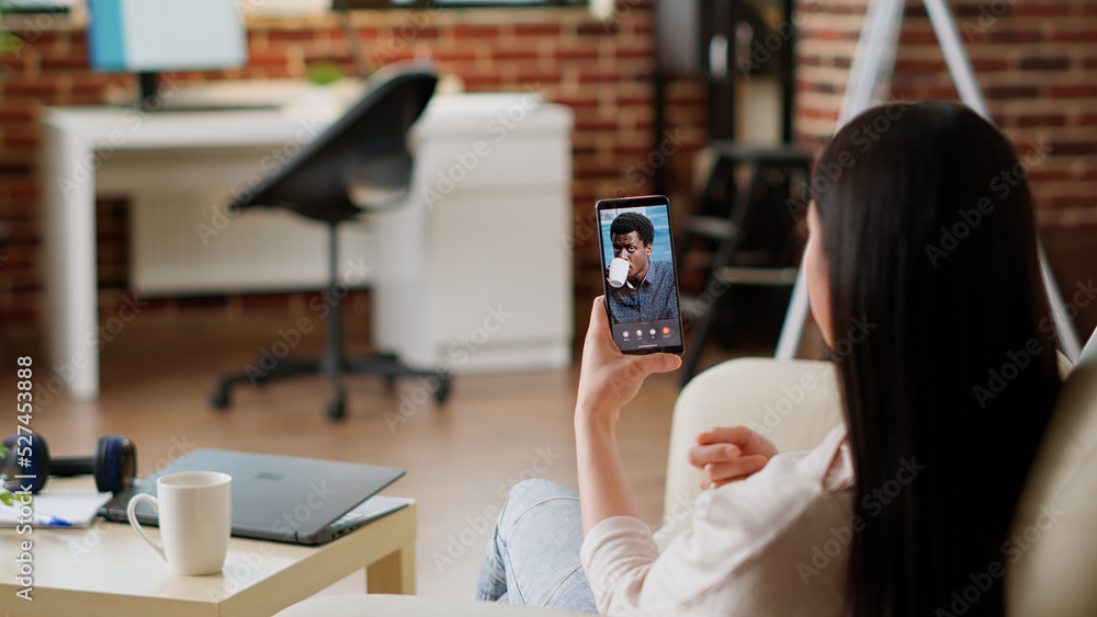 Poster employee working remotely from home while using talking with coworker on virtual online videoconfere