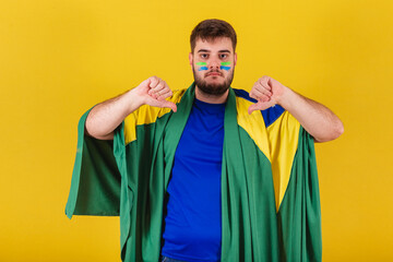 brazilian caucasian man, brazil soccer fan, thumb down, disapproval, dislike, bad