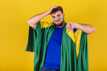 brazilian caucasian man, brazil soccer fan, thumb down, disapproval, dislike, bad