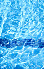 Defocus blurred blue watercolor in swimming pool rippled water