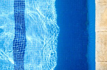 Blue mosaic bathroom or kitchen tile wall. Ceramic tiled floor or swimming pool