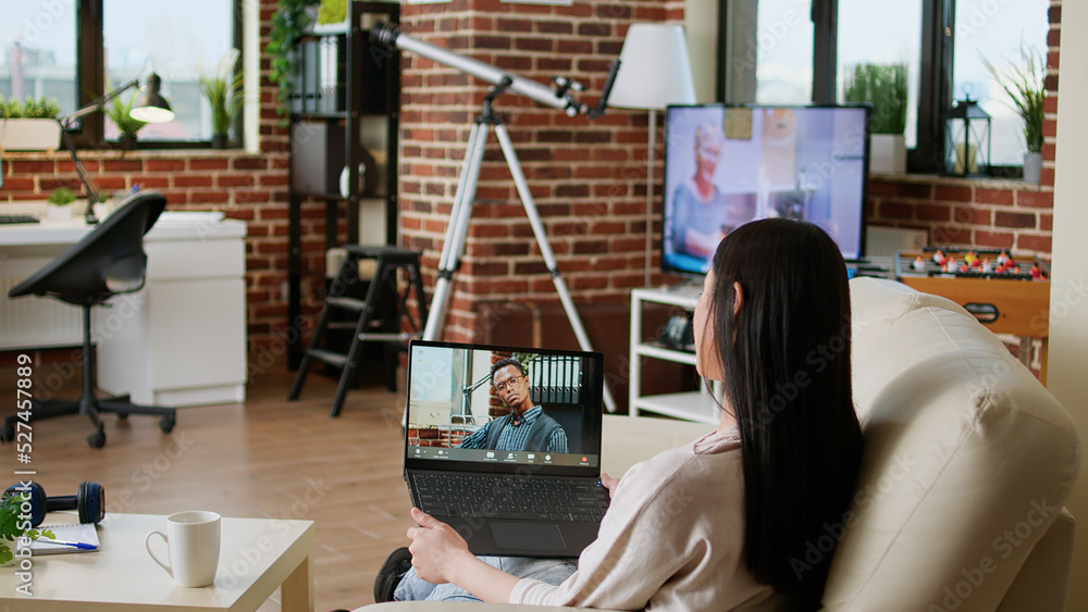 Poster office employee working remotely while attending online video call with executive manager on laptop 