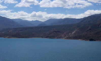 Beautiful scenery with a lake and mountains on a cloudy day.
