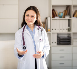 Positive female doctor posing in clinic