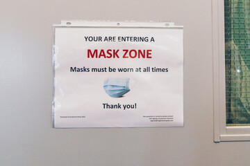 Sign on a door for entering a Mask Zone, face masks are required beyond this point due to the COVID-19 pandemic