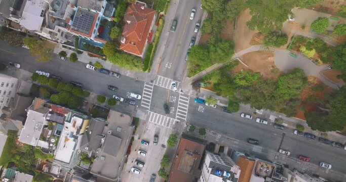 Usual crossroads in one of the streets of San Francisco. Some cars going by the roads of the city. Top view.
