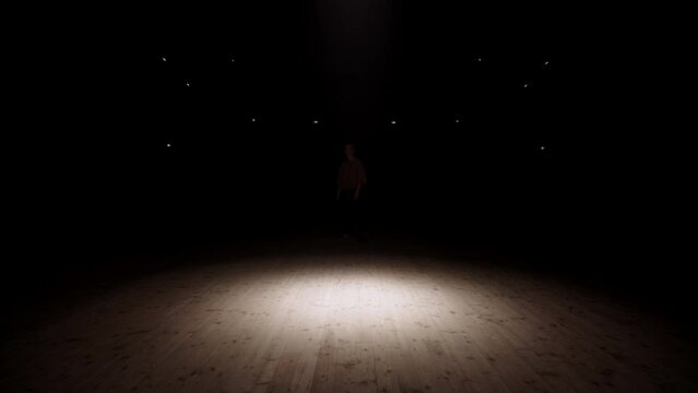 teen girl is dancing hip-hop in soffit light, active and confident dancer in battle of street dance