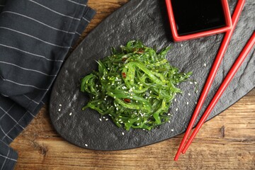 Japanese seaweed salad served on wooden table, flat lay © New Africa