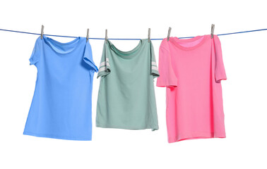 Different clothes drying on washing line against white background