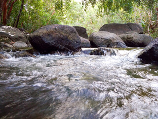 Naklejka na ściany i meble Stream in the forest. Natural tourism Batu Mentas, Belitung Island.