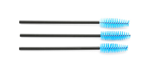 Three brushes for eyelashes on white background, top view