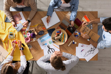 Fashion designer creating new clothes in studio, top view
