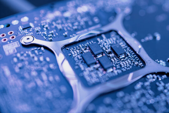 Tilt-shift lens view of capacitors on workstation professional video card GPU for CAD CGI scientific machine learning - blue color cast