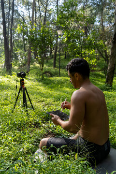 Hispanic Latino Man Giving Class, While Being Recorded By A Camera, Holding Ipad Or Tablet In His Hand, Mexico