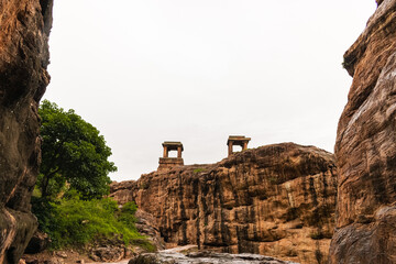 The Badami open Mandapas, perhaps once part of a Chalukya palace, are balanced on cliffs with...