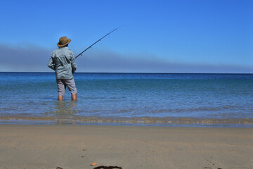 Australian man fishing on a remote beach