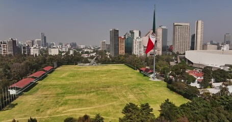 Mexico City Aerial v95 drone flyover bosque de chapultepec park across campo marte field with mexican flag, capturing polanco neighborhood cityscape - Shot with Mavic 3 Cine - January 2022