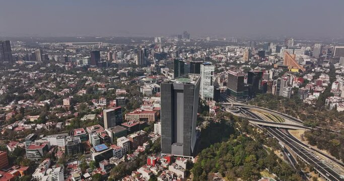 Mexico City Aerial v85 drone fly around lomas de chapultepec neighborhood capturing polanco downtown cityscape and overpass traffics at daytime - Shot with Mavic 3 Cine - January 2022