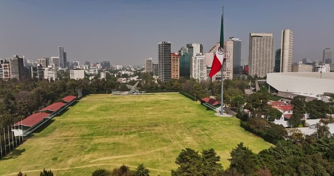 Mexico City Aerial v95 drone flyover bosque de chapultepec park across campo marte field with mexican flag, capturing polanco neighborhood cityscape - Shot with Mavic 3 Cine - January 2022