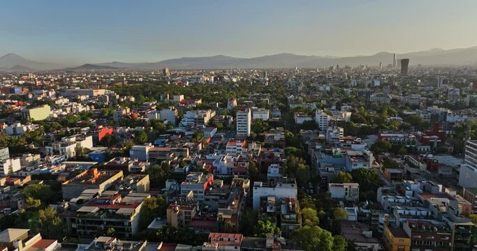 Mexico City Aerial v12 cinematic dolly in shot, drone flying south across roma norte neighborhod capturing populous urban cityscape at sunset - Shot with Mavic 3 Cine - December 2021