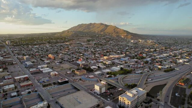 El Paso Texas USA. Aerial Drone Shot Of El Paso Central Area With Franklin Mountains In The Background During Sunset With Cars Driving On I-10 Freeway.