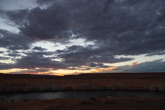 Dark clouds at sunset over Colorado River, Arizona © Martina