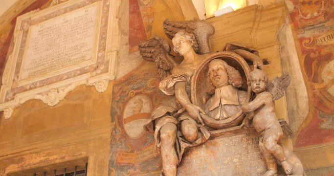 Beautiful detailed view of inner courtyard of historic and famous Archiginnasio statue in Bologna, Italy.