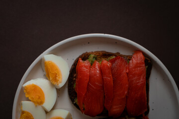 Sandwiches with red fish and boiled egg.