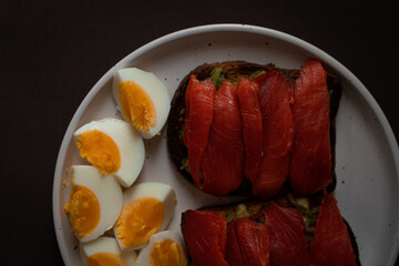 Sandwiches with red fish and boiled egg.