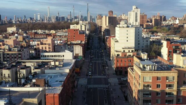 Aerial flight down empty street of Harlem NYC during the Covid-19 pandemic lockdown on a sunny day