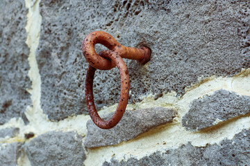 old rusty horse tether ring on bluestone wall