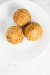 top view of 3 coxinhas in a white plate - brazilian food, chicken croquette
