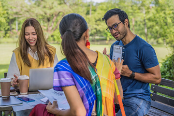 diversity of businessperson coworkers working and brainstorming together in pupblic park