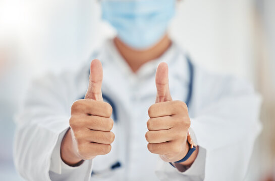 Thumbs up doctor hand sign for covid surgery success, support and yes in a hospital. Medical and healthcare worker showing thank you, agreement or goal completion hands gesture in a health clinic