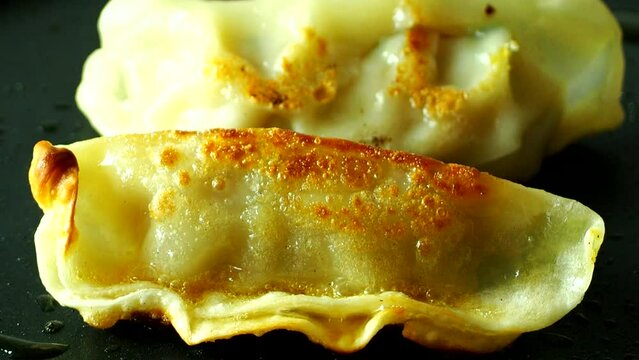 Frying dumpling in pan, in door Chiangmai Thailand.