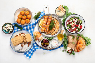 Greek cuisine dishes on neutral background.