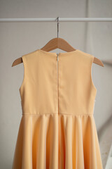 Yellow dress hanging on a hanger