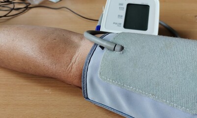 Portrait showing blood pressure measurement of the male patient, concept health care.